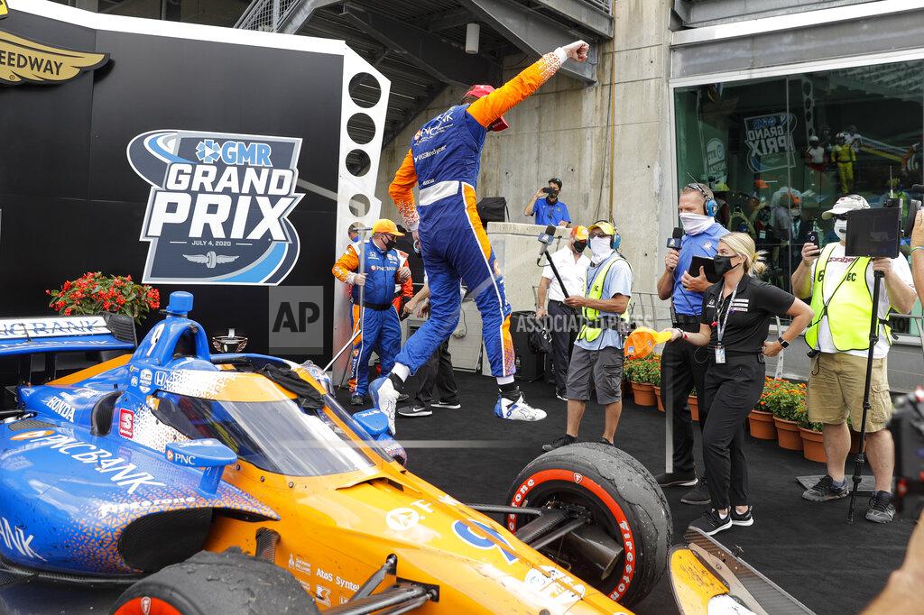 Darron Cummings Race driver Scott Dixon, of New Zealand, jumps off his car after winning the IndyCar auto race at Indianapolis Motor Speedway in Indianapolis, Saturday, July 4, 2020. (AP Photo/Darron Cummings)