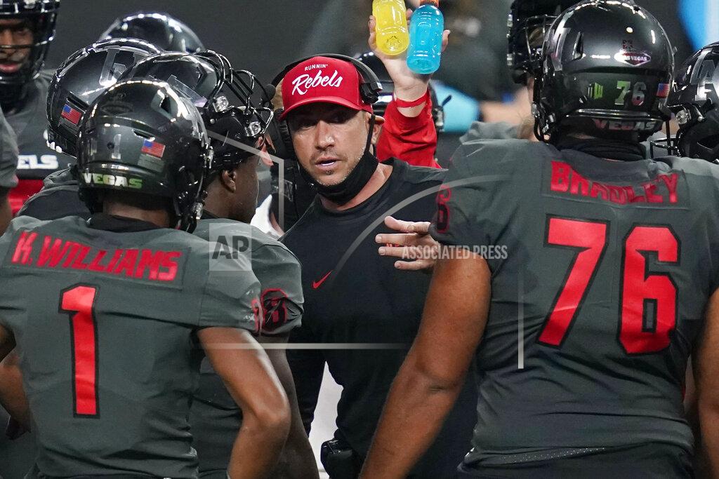 John Locher UNLV head coach Marcus Arroyo speaks with his players during the second half of an NCAA college football game against Nevada, Saturday, Oct. 31, 2020, in Las Vegas. (AP Photo/John Locher)