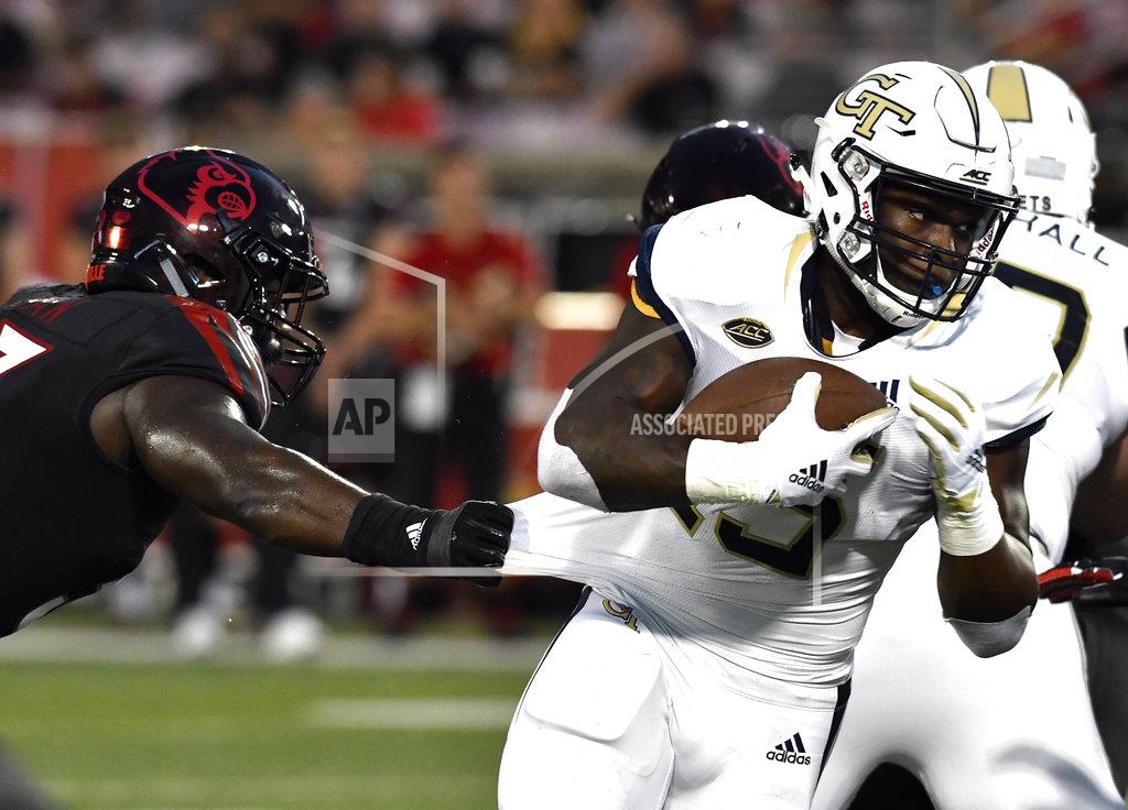 Timothy D. Easley Louisville defensive end Amonte Caban (53) grabs the jersey of Georgia Tech running back Jerry Howard (15) during the first half of an NCAA college football game, Friday, Oct. 5, 2018, in Louisville, Ky. (AP Photo/Timothy D. Easley)
