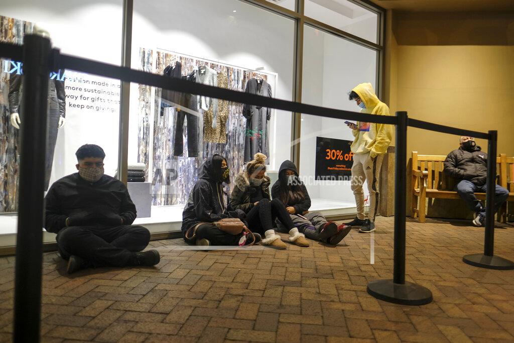 Ringo H.w. Chiu Black Friday shoppers wait in line to enter an shore that opened at 6am at the Citadel Outlets in Commerce, Calif., Friday, Nov. 27, 2020. (AP Photo/Ringo H.W. Chiu)