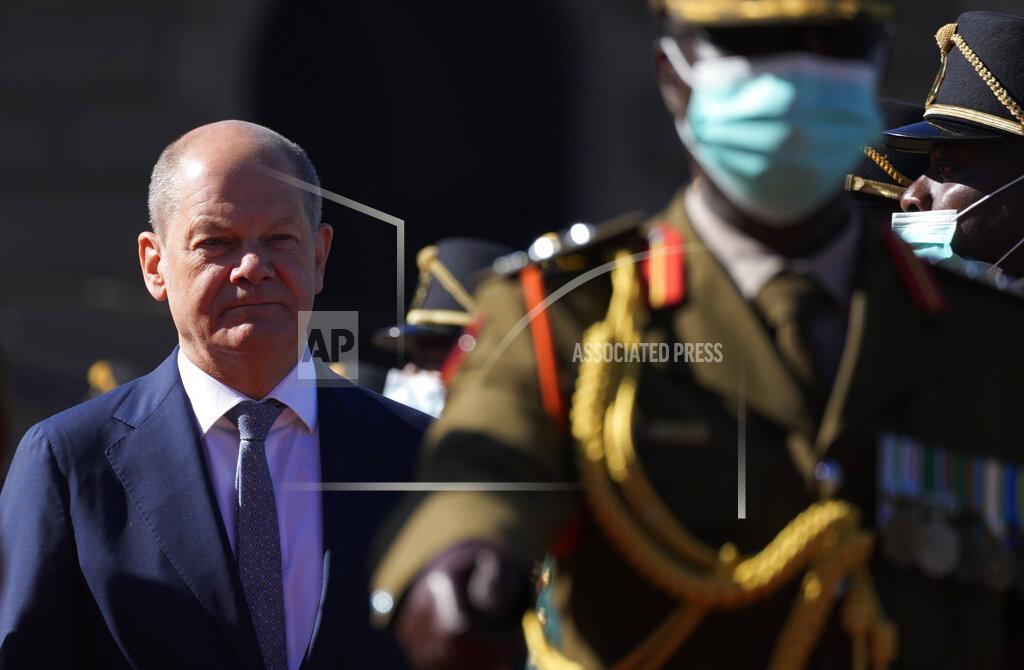 Themba Hadebe German Chancellor Olaf Scholz, left, walks as he inspects a guard of honour during the official welcoming ceremony at the Union Building in Pretoria, South Africa, Tuesday, May 24, 2022. (AP Photo/Themba Hadebe)