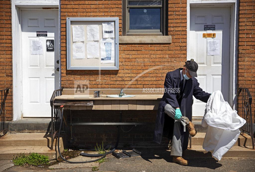 David Goldman Rabbi Shmuel Plafker removes his protective suit after conducting seven burials Monday, April 6, 2020, as the chaplain for the Hebrew Free Burial Association at their cemetery in the Staten Island borough of New York. "It's ironic," said Plafker as he reflects after burying another potential coronavirus victim. "Spring is here. Everything is in bloom and people are dying." (AP Photo/David Goldman)