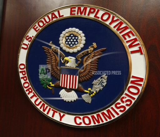 FILE - The emblem of the U.S. Equal Employment Opportunity Commission is shown on a podium in Vail, Colo., Tuesday, Feb. 16, 2016, in Denver. A woman who was fired after asking to bring an oxygen tank to work to help her breathe will get $25,000 in a federal settlement. TriMark Foodcraft also agreed to train its staff on what qualifies as reasonable accommodations under the Americans with Disabilities Act under a two-year consent decree with the U.S. Equal Employment Opportunity Commission, the agency said. (AP Photo/David Zalubowski)