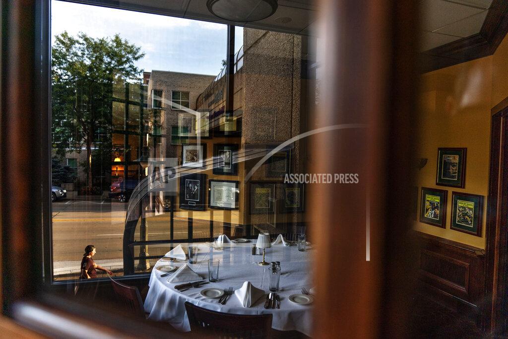 David Goldman A set table sits empty inside the closed Vince Lombardi's Steakhouse in Appleton, Wis., Aug. 20, 2020. Appleton is testimony to the lack of simple solutions to the coronavirus pandemic. Nearly 40% of the city's leisure and hospitality jobs have been lost. Restaurants have been closed, hotels vacant. (AP Photo/David Goldman)