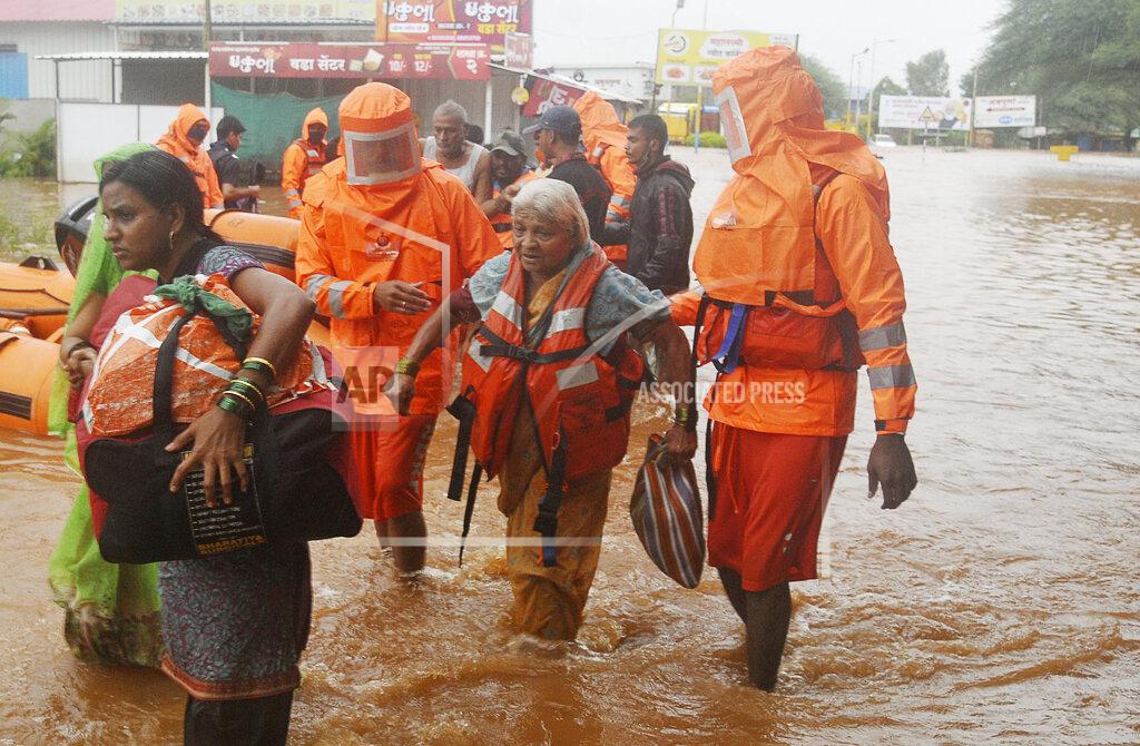 Uncredited National Disaster Response Force personnel rescue people stranded in floodwaters in Kolhapur, in the western Indian state of Maharashtra, Friday, July 23, 2021. Landslides triggered by heavy monsoon rains hit parts of western India, killing at least 32 people and leading to the overnight rescue of more than 1,000 other people trapped by floodwaters, officials said Friday. (AP Photo)