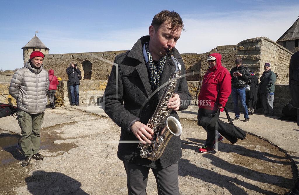 Dmitri Lovetsky Russian saxophonist Alexey Kruglov performs in the Ivangorod Fortress on the Russian-Estonian border in Ivangorod, 130 km (80 miles) west of St.Petersburg, Russia, Friday, April 30, 2021. Musicians on the Estonian-Russian border held an unusual concert on Friday, with Estonian guitarist Jaak Sooaar and Russian saxophonist Alexey Kruglov performing from the castles on the opposing banks of the Narva river that marks the border between the two countries. The concert was held on the International Jazz Day by the two musicians as an act of friendship despite the deteriorating relations between the two countries and as cross-border contacts have been limited due to the corona-virus pandemic. (AP Photo/Dmitri Lovetsky)