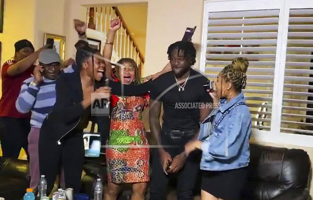 Uncredited In this still image from video provided by the NFL, Brandon Aiyuk, second from right, is congratulated while watching the NFL football draft, Thursday, April 23, 2020, in Reno, Nev. The San Francisco 49er selected Aiyuk in the first round. (NFL via AP)
