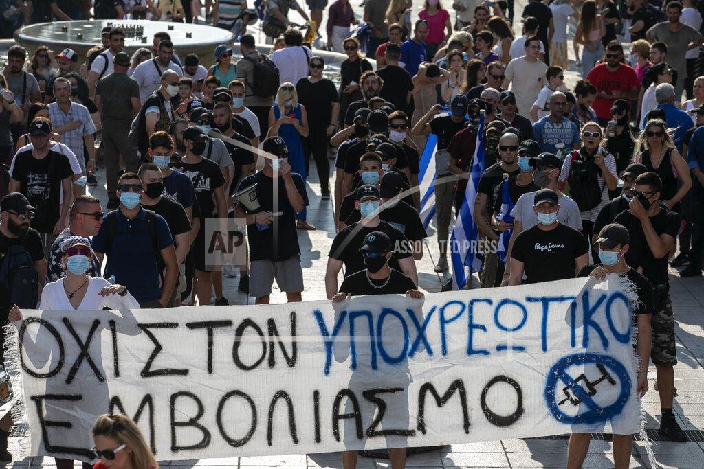 Yorgos Karahalis Anti-vaccine protesters hold a banner during a rally at Syntagma square, central Athens, on Wednesday, July 21, 2021. Thousands of people protested against Greek government's measures to curb rising COVID-19 infections and drive up vaccinations in the country where almost 50% of Greeks and country residents have received at least one dose of the vaccine. The banner reads :" No to mandatory vaccination". (AP Photo/Yorgos Karahalis)