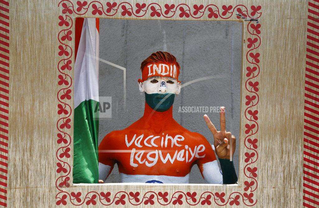 Ajit Solanki Rajkumar Haryani, 38, poses for photographs after getting a dose of Covishield, Serum Institute of India's version of the AstraZeneca COVID-19 vaccine, in Ahmedabad, India, Saturday, June 12, 2021. Rajkumar painted his body to create awareness about vaccination. (AP Photo/Ajit Solanki)