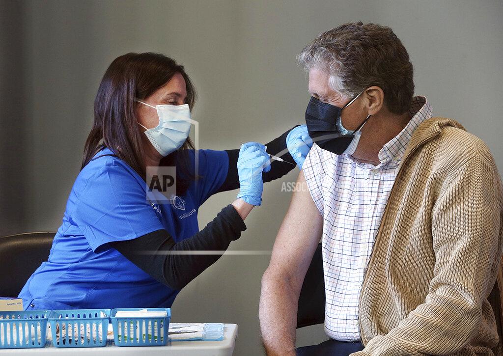 Bob Breidenbach Nurse Kerry Stanchina, of The Wellness Company, administers a COVID-19 vaccine to Rhode Island Lt. Gob. Daniel J. McKee, Tuesday, March 2, 2021, at the Dunkin Donuts Center in Providence, R.I. (Bob Breidenbach/Providence Journal via AP)