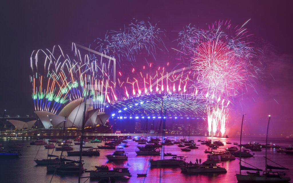 Mark Baker Fireworks explode over the Sydney Opera House and Harbour Bridge as New Year celebrations begin in Sydney, Australia, Friday, Jan. 1, 2021. One million people would usually crowd the Sydney Harbor to watch the annual fireworks that center on the Sydney Harbour Bridge. But this year authorities advised revelers to watch the fireworks on television as the two most populous states, New South Wales and Victoria battle to curb new COVID-19 outbreaks. (AP Photo/Mark Baker)