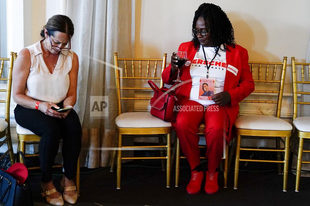 Brynn Anderson Monica Kinnebrew, of Perry Ga., left, and Krystal Daniel, of Atlanta, await U.S. Senate candidate Herschel Walker during an election night watch party, Tuesday, May 24, 2022, in Atlanta.(AP Photo/Brynn Anderson)