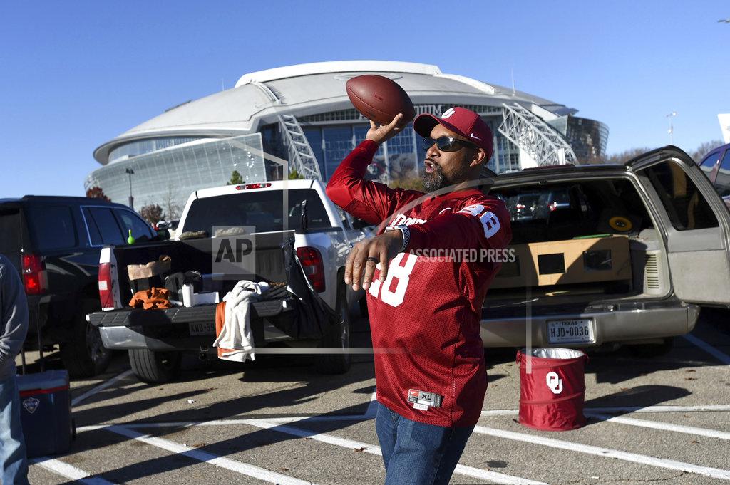 Jeffrey Mcwhorter Oklahoma fan Adrian Martin, of Norman, Oklahoma, tosses a football at a tailgate party before the Big 12 Conference championship NCAA college football game against Texas on Saturday, Dec. 1, 2018, in Arlington, Texas. (AP Photo/Jeffrey McWhorter)