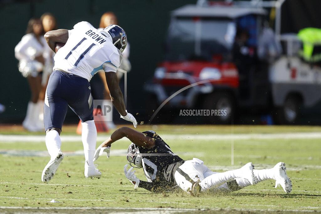 Ben Margot Tennessee Titans wide receiver A.J. Brown (11) runs past Oakland Raiders cornerback Daryl Worley to score during the first half of an NFL football game in Oakland, Calif., Sunday, Dec. 8, 2019. (AP Photo/Ben Margot)