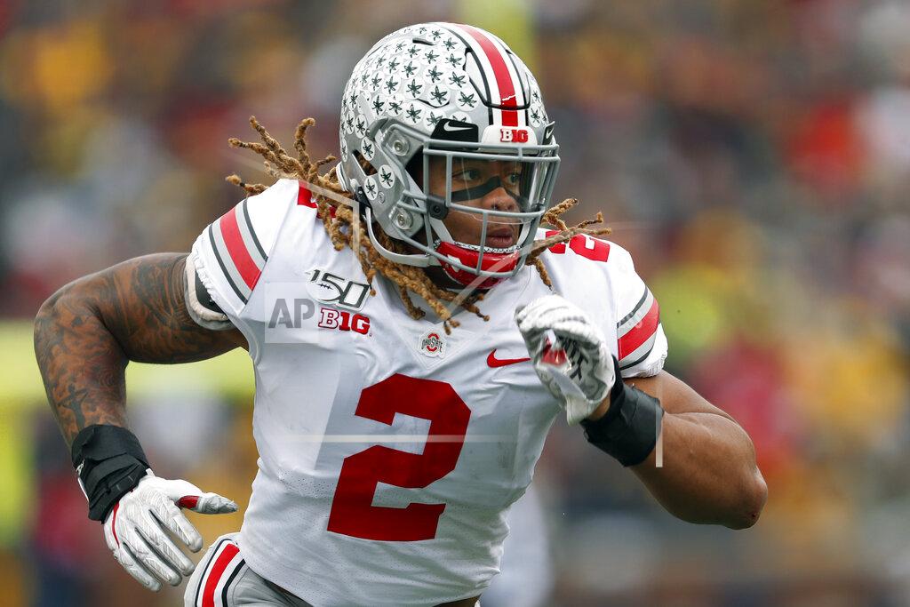 FILE - In this Nov. 30, 2019, file photo, Ohio State defensive end Chase Young plays against Michigan in the first half of an NCAA college football game, in Ann Arbor, Mich. Record-setting defensive end Chase Young is leaving Ohio State early to enter the NFL draft, a widely expected move. The junior Heisman Trophy finalist made the announcement Friday, Jan. 3, 2020, on Twitter. He says he looks forward to "joining a new family in the NFL this spring and being part of something special.” (AP Photo/Paul Sancya, File)