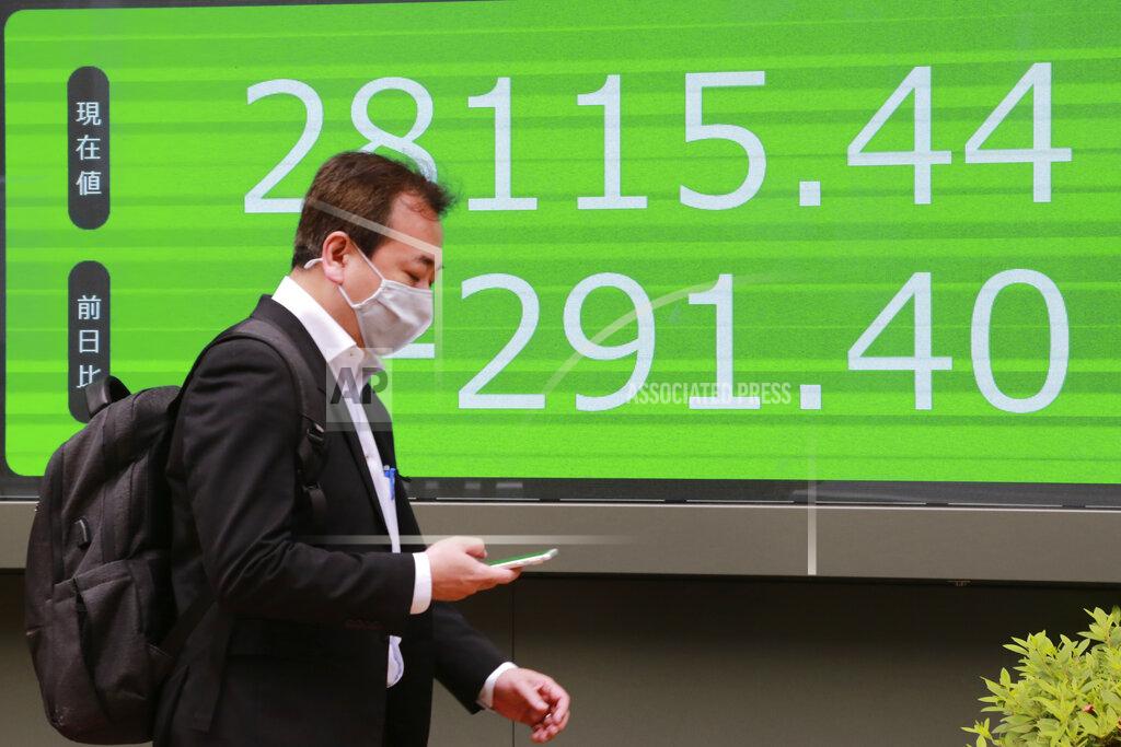 Koji Sasahara A man walks by an electronic stock board of a securities firm in Tokyo, Wednesday, May 19, 2021. Asian shares fell Wednesday, tracking a decline on Wall Street led by big technology stocks. (AP Photo/Koji Sasahara)