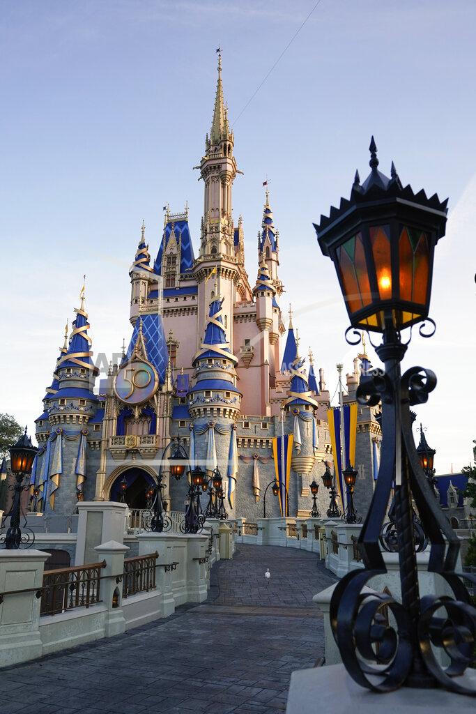 John Raoux The newly painted Cinderella Castle at the Magic Kingdom at Walt Disney World is seen with the the crest to celebrate the 50th anniversary of the theme park Monday, Aug. 30, 2021, in Lake Buena Vista, Fla. (AP Photo/John Raoux)