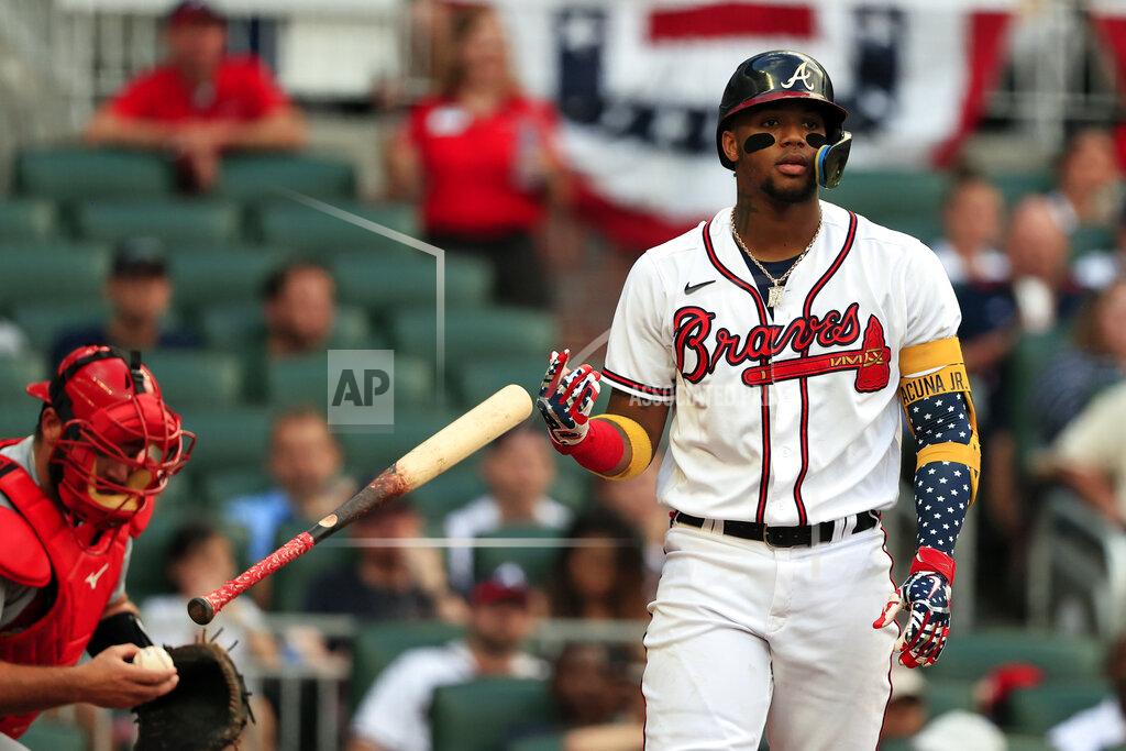 Butch Dill Atlanta Braves' Ronald Acuna Jr. tosses his bat as he walks to first on a walk during the second inning of a baseball game against the St. Louis Cardinals, Monday, July 4, 2022, in Atlanta. (AP Photo/Butch Dill)
