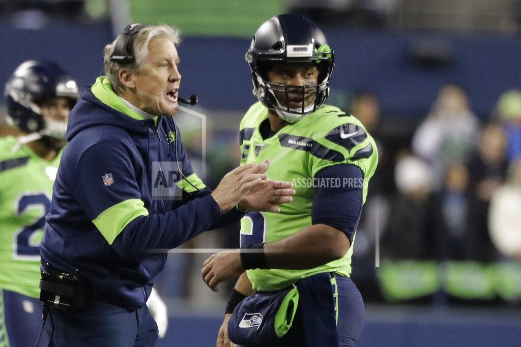 Ted S. Warren Seattle Seahawks head coach Pete Carroll, left, talks with quarterback Russell Wilson during the first half of an NFL football game against the Minnesota Vikings, Monday, Dec. 2, 2019, in Seattle. (AP Photo/Ted S. Warren)