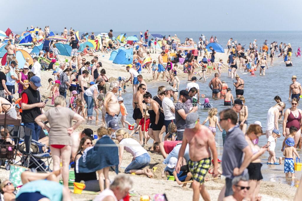 Mohssen Assanimoghaddam Numerous beach visitors are at summery temperatures on the North Sea beach of Schillig, Germany, Saturday, July 18, 2020. (Mohssen Assanimoghaddam/dpa via AP)