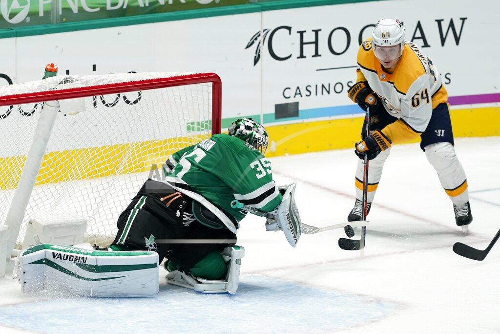 Tony Gutierrez Dallas Stars goaltender Anton Khudobin (35) defends against a shot by Nashville Predators center Mikael Granlund (64) during the second period of an NHL hockey game in Dallas, Friday, Jan. 22, 2021. (AP Photo/Tony Gutierrez)