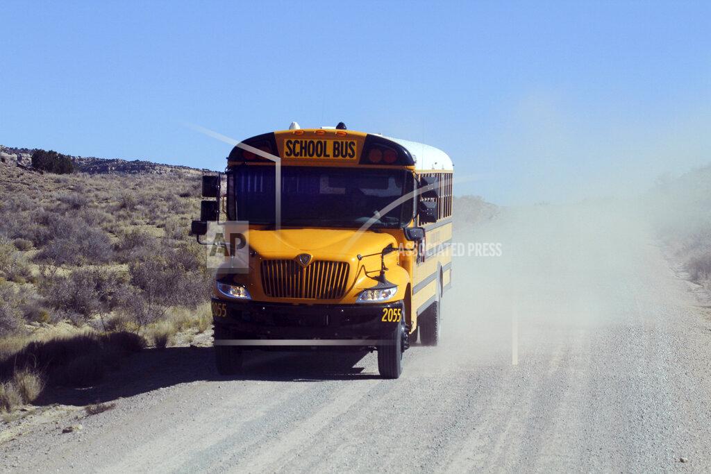 Cedar Attanasio A school bus driven by Kelly Maestas travels along a dirt road outside Cuba, N.M., Oct. 19, 2020. The switch to remote learning in rural New Mexico has left some students profoundly isolated — cut off from others and the grid by sheer distance. The school system is sending school buses to students' far-flung homes to bring them assignments, meals and a little human contact. (AP Photo/Cedar Attanasio)