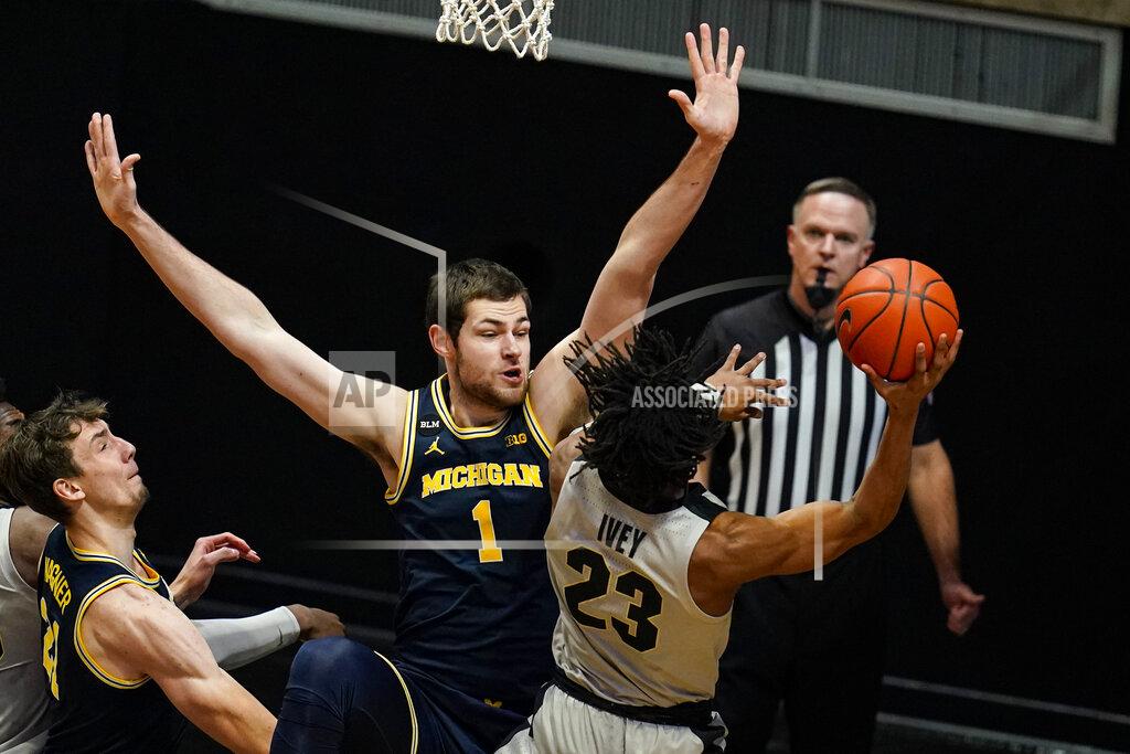 Michael Conroy Purdue guard Jaden Ivey (23) shoots over Michigan center Hunter Dickinson (1) during the first half of an NCAA college basketball game in West Lafayette, Ind., Friday, Jan. 22, 2021. (AP Photo/Michael Conroy)