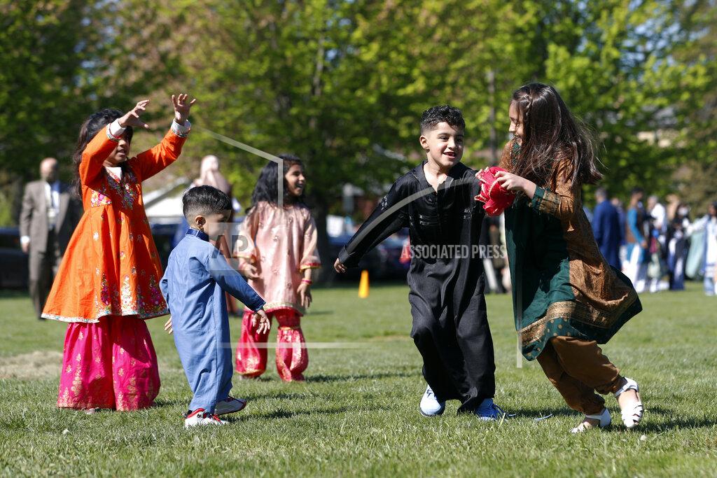 Shafkat Anowar Muslim children plays in an outdoor open area after performing an Eid al-Fitr prayer marking the end of the fasting month of Ramadan, Thursday, May 13, 2021 in Morton Grove, Ill. (AP Photo/Shafkat Anowar)