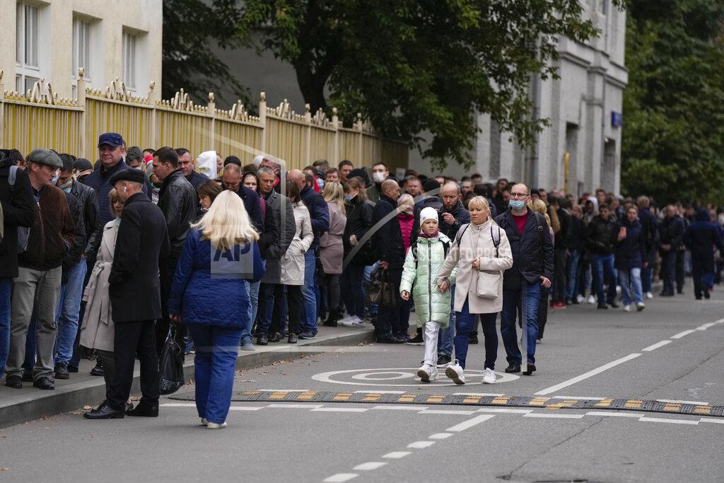 Pavel Golovkin People stand in line to a polling station during parliamentary elections in Moscow, Russia, Friday, Sept. 17, 2021. Russia has begun three days of voting for a new parliament that is unlikely to change the country's political complexion. There's no expectation that United Russia, the party devoted to President Vladimir Putin, will lose its dominance in the State Duma. (AP Photo/Pavel Golovkin)