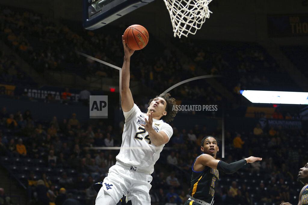 Kathleen Batten West Virginia forward Patrick Suemnick (24) shoots while defended by Morehead State guard Kalil Thomas (15) during the second half of an NCAA college basketball game in Morgantown, W.Va., Tuesday, Nov. 15, 2022. (AP Photo/Kathleen Batten)