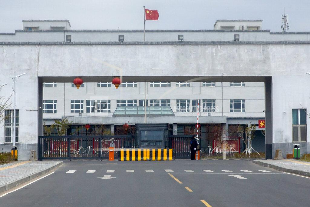 Mark Schiefelbein FILE - Police officers stand at the outer entrance of the Urumqi No. 3 Detention Center in Dabancheng in western China's Xinjiang Uyghur Autonomous Region on April 23, 2021. State officials took AP journalists on a tour of a "training center" turned detention site in Dabancheng sprawling over 220 acres and estimated to hold at least 10,000 prisoners - making it by far the largest detention center in China and among the largest on the planet. (AP Photo/Mark Schiefelbein, File)
