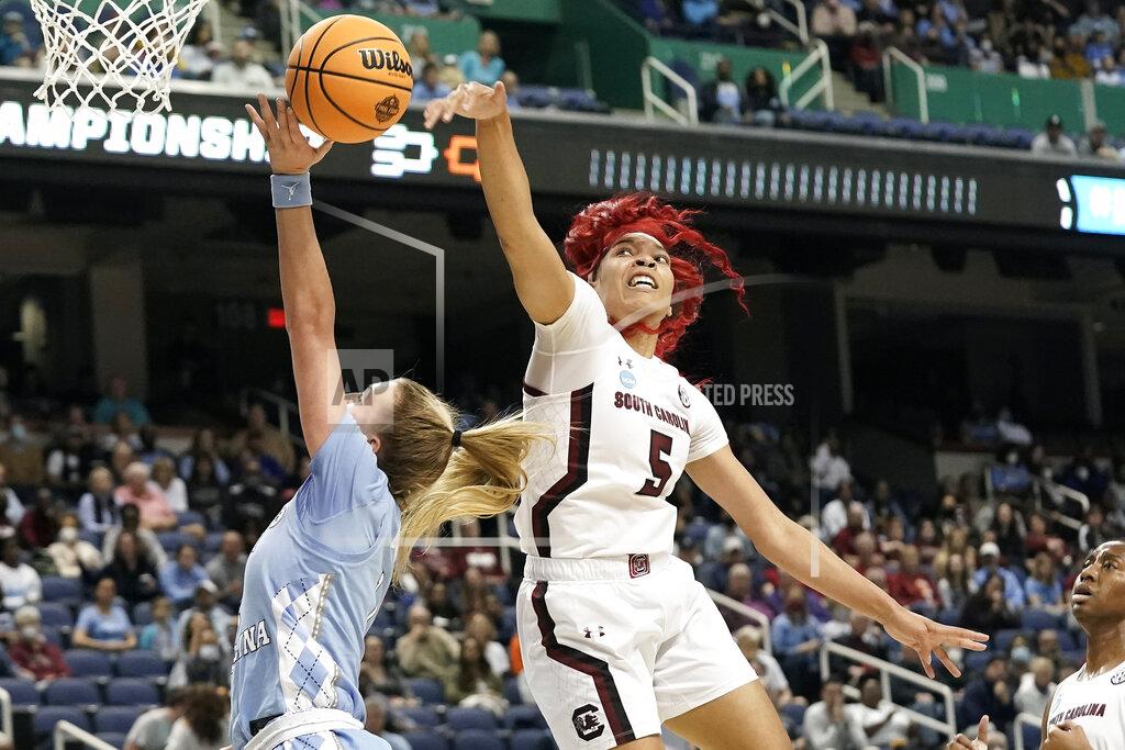 Gerry Broome South Carolina forward Victaria Saxton (5) blocks a shot by North Carolina guard Alyssa Ustby during the first half of a college basketball game in the Sweet 16 round of the NCAA tournament in in Greensboro, N.C., Friday, March 25, 2022. (AP Photo/Gerry Broome)