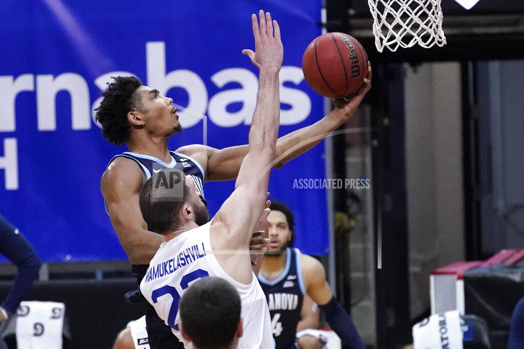 Mary Altaffer Villanova forward Jermaine Samuels, top, goes to the basket past Seton Hall forward Sandro Mamukelashvili (23) during the second half of an NCAA college basketball game, Saturday, Jan. 30, 2021, in Newark, N.J. (AP Photo/Mary Altaffer)