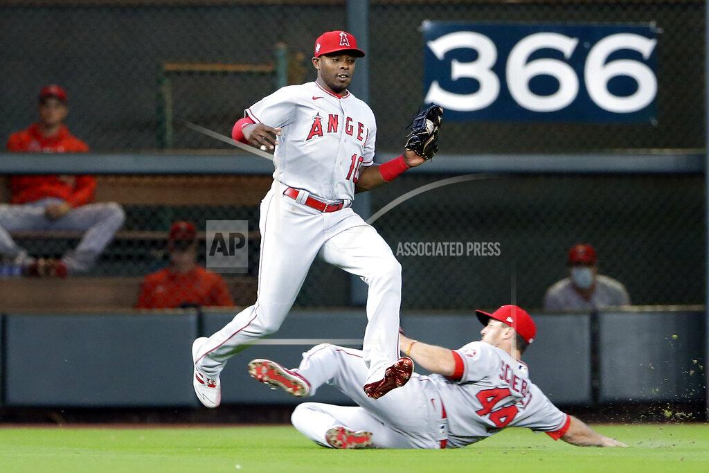 Michael Wyke Los Angeles Angels left fielder Justin Upton (10) jumps to avoid right fielder Scott Schebler (44) as they both go to make the out on the fly by Houston Astros' Alex Bregman during the fourth inning of a baseball game Sunday, April 25, 2021, in Houston. (AP Photo/Michael Wyke)