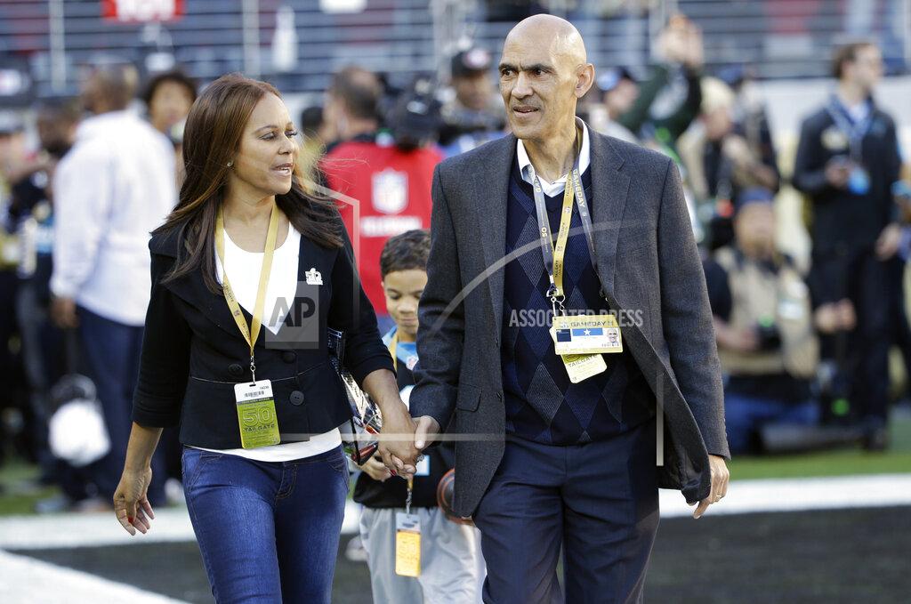 Marcio Jose Sanchez FILE - In this Feb. 7, 2016, file photo, former NFL football player and head coach Tony Dungy, right, walks with his wife Lauren Harris Dungy before the NFL Super Bowl 50 football game between the Denver Broncos and the Carolina Panthers in Santa Clara, Calif. The Pro Football Hall of Famer and his wife recently penned their fourth book in a children’s series. The new one is titled “Carson Chooses Forgiveness,” and it follows “We Chose You,” which focuses on adoption; “Maria Finds Courage,” and “Austin Plays Fair.” (AP Photo/Marcio Jose Sanchez, File)