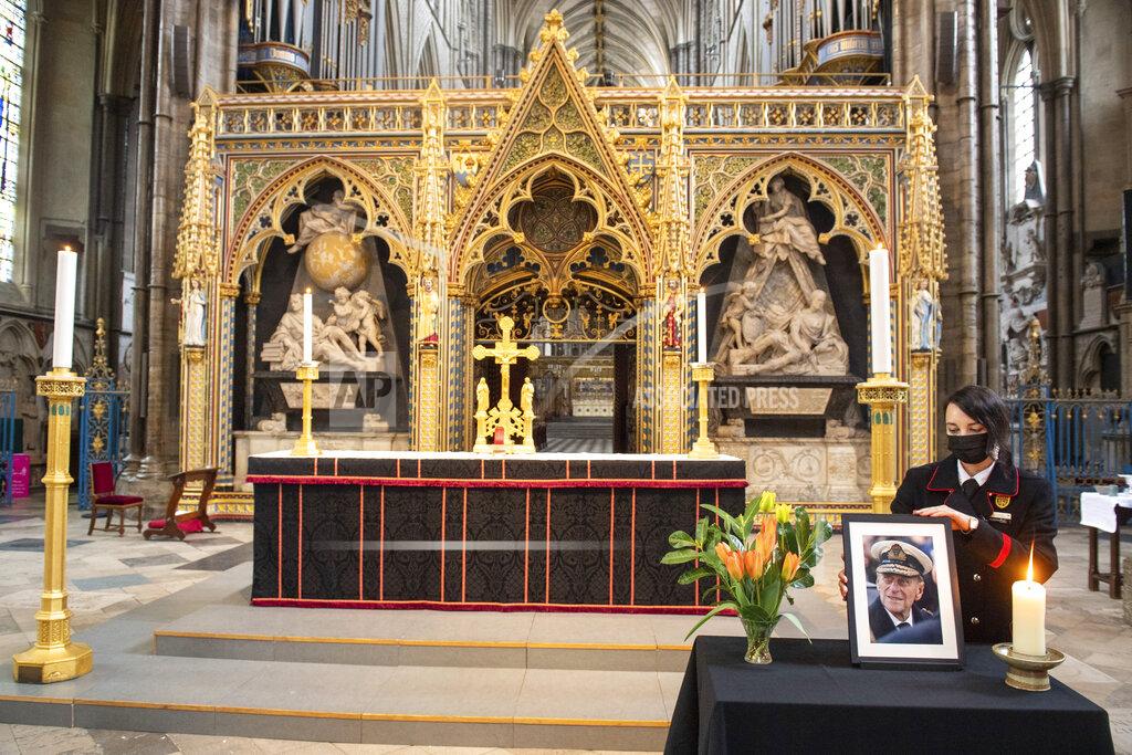 Dominic Lipinski A photograph of Britain's Prince Philip, the Duke of Edinburgh, is displayed alongside the nave at Westminster Abbey, London, Saturday April 10, 2021, which has been dressed in black to mark his death. (Dominic Lipinski/PA via AP)