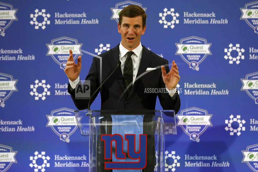 FILE - New York Giants NFL football quarterback Eli Manning announces his retirement in East Rutherford, N.J., in this Friday, Jan. 24, 2020, file photo. Eli Manning has a new job with the New York Giants. The two-time Super Bowl MVP is rejoining the organization to work in business opportunities and fan initiatives. The Giants announced the hiring Monday, June 21, 2021, roughly 18 months after Manning retired following the 2019 season. (AP Photo/Adam Hunger, File)