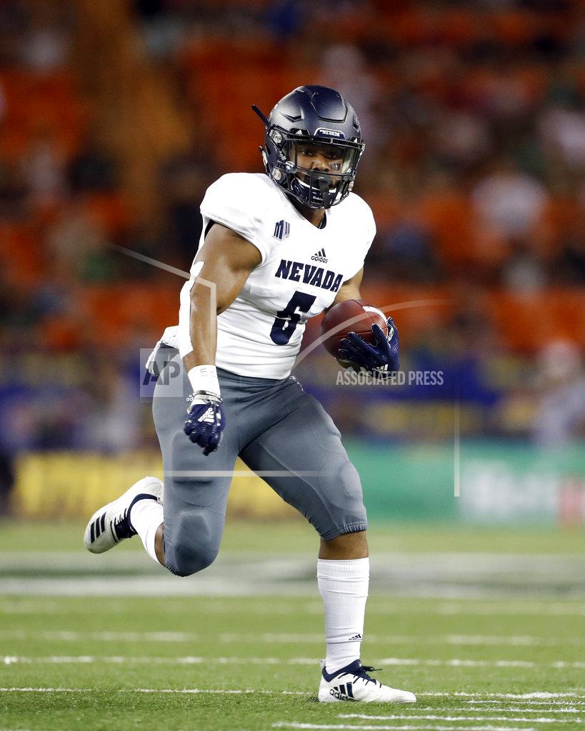 Marco Garcia Nevada running back Jaxson Kincaide (5) runs through the Hawaii defensive line during the second quarter of an NCAA college football game, Saturday, Oct. 20, 2018, in Honolulu. (AP Photo/Marco Garcia)