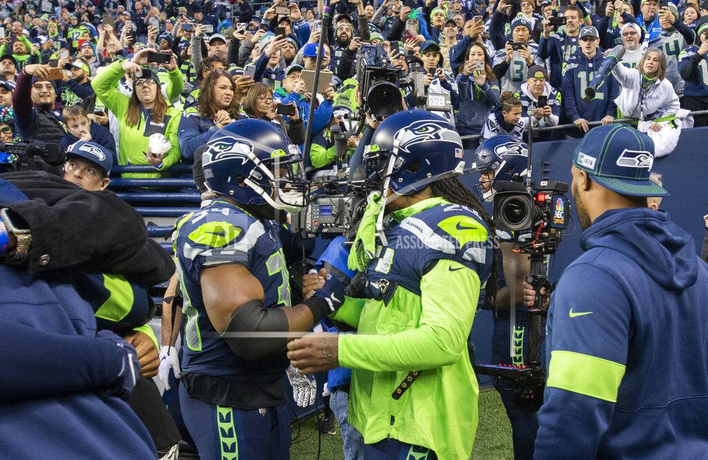 Drew Perine Newly signed running backs and former Seahawks teammates Robert Turbin, left, and Marshawn Lynch embrace during warmups at CenturyLink Field in Seattle on Sunday, Dec. 29, 2019. (Drew Perine/The News Tribune via AP)