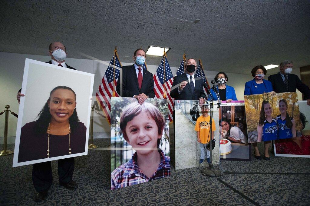 Jose Luis Magana From left, Sen. Chris Coons, D-Del., Sen. Richard Blumenthal, D-Conn., Sen. Dick Durbin, D-Ill., Sen. Mazie Hirono, D-Hawaii, Sen. Amy Klobuchar, D-Minn., and Sen. Sheldon Whitehouse, D-R.I., hold photographs of people who where saved due the Affordable Care Act (ACA) during a news conference, after the confirmation hearing of President Donald Trump's Supreme Court nominee Amy Coney Barrett, in Washington, Monday, Oct. 12, 2020. (AP Photo/Jose Luis Magana)