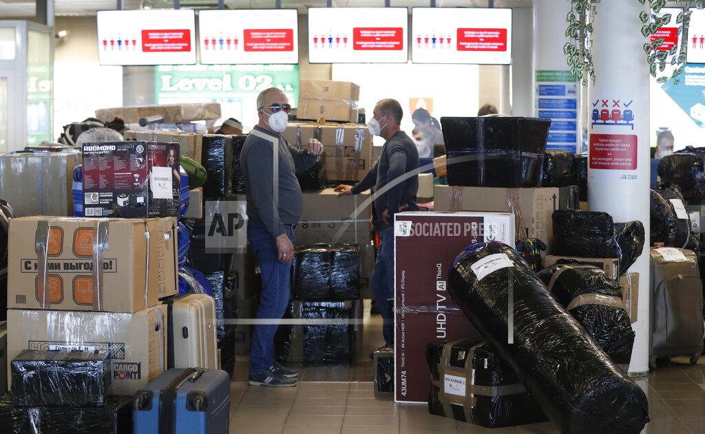 Petr David Josek People check in luggages at the Vaclav Havel airport after a Russian special government plane landed in Prague, Czech Republic, Monday, April 19, 2021. Czech Republic is expelling 18 diplomats identified as spies over a 2014 ammunition depot explosion. On Saturday, April 17, 2021, Prime Minister Andrej Babis said the Czech spy agencies provided clear evidence about the involvement of Russian military agents in the massive explosion that killed two people. (AP Photo/Petr David Josek)