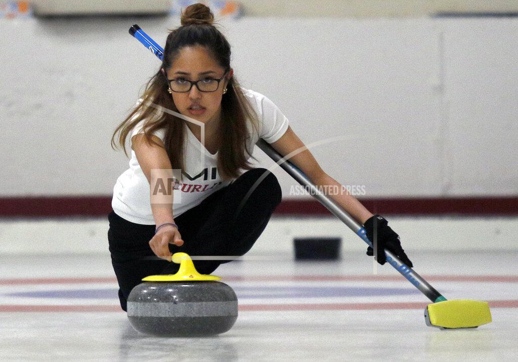 Bill Sikes Kika Arias, of the Massachusetts Institute of Technology, delivers a rock during the college curling national championship, Friday, March 8, 2019, in Wayland, Mass. (AP Photo/Bill Sikes)