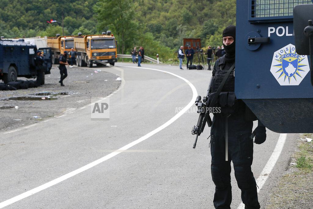 Visar Kryeziu Kosovo police officers patrol a road near the northern Kosovo border crossing of Jarinje, Tuesday, Sept. 21, 2021. Tensions soared Monday when Kosovo special police with armored vehicles were sent to the border to impose a rule on temporarily replacing Serb license plates from cars while they drive in Kosovo. (AP Photo/Visar Kryeziu)