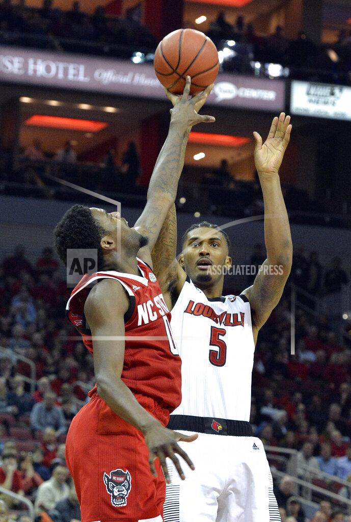 Timothy D. Easley North Carolina State forward DJ Funderburk (0) gets a finger on the shot of Louisville center Malik Williams (5) during the second half of an NCAA college basketball game in Louisville, Ky., Thursday, Jan. 24, 2019. Louisville won 84-77. (AP Photo/Timothy D. Easley)