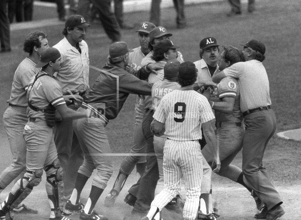 FILE - In this July 24, 1983, file photo, Kansas City Royals' George Brett, second from right, is restrained by umpire Joe Brinkman after his bat was ruled illegal because of pine tar beyond the legal limit on the handle during a baseball game against the New York Yankees at Yankee Stadium in New York. Nearly three decades after it became known simply as