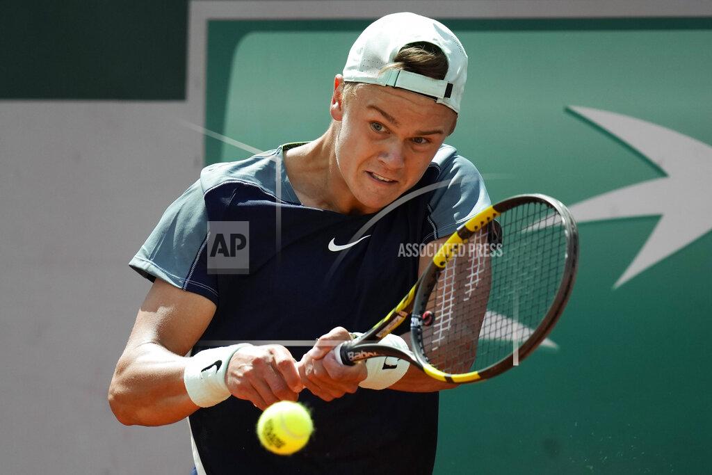 Christophe Ena Denmark's Holger Rune plays a shot against Canada's Denis Shapovalov during their first round match at the French Open tennis tournament in Roland Garros stadium in Paris, France, Tuesday, May 24, 2022. (AP Photo/Christophe Ena)