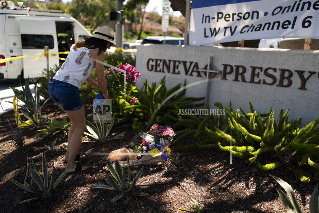 Jae C. Hong FILE - Joanna Garcia, 47, leaves flowers outside Geneva Presbyterian Church to honor victims in Sunday's shooting at the church in Laguna Woods, Calif., Monday, May 16, 2022. After a weekend of gun violence in America, when shootings killed and wounded people grocery shopping, going to church and simply living their lives, the nation marked a milestone of 1 million deaths from COVID-19. The number, once unthinkable, is now a pedestrian reality in the United States, just as is the reality of the continuing epidemic of gun violence that kills tens of thousands of people a year. (AP Photo/Jae C. Hong, File)