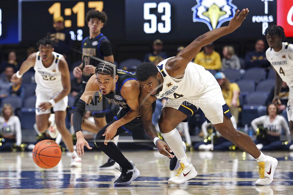 Kathleen Batten Morehead State guard Kalil Thomas (15) and Morehead State guard Chris Cole (14) go for loose ball during the second half of an NCAA college basketball game in Morgantown, W.Va., Tuesday, Nov. 15, 2022. (AP Photo/Kathleen Batten)