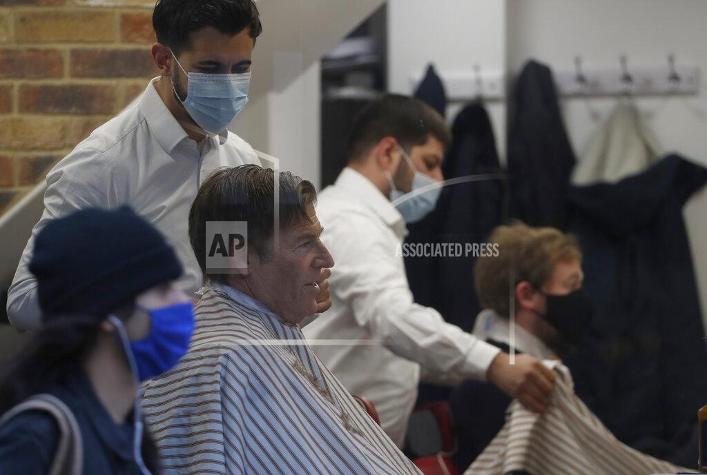 Alastair Grant The Lord Mayor of London William Russell gets his hair cut by Ali Baltar, owner of the Grooming Lounge in the City of London, Monday, April 12, 2021. Millions of people in England will get their first chance in months for haircuts, casual shopping and restaurant meals on Monday, as the government takes the next step on its lockdown-lifting road map. (AP Photo/Alastair Grant)
