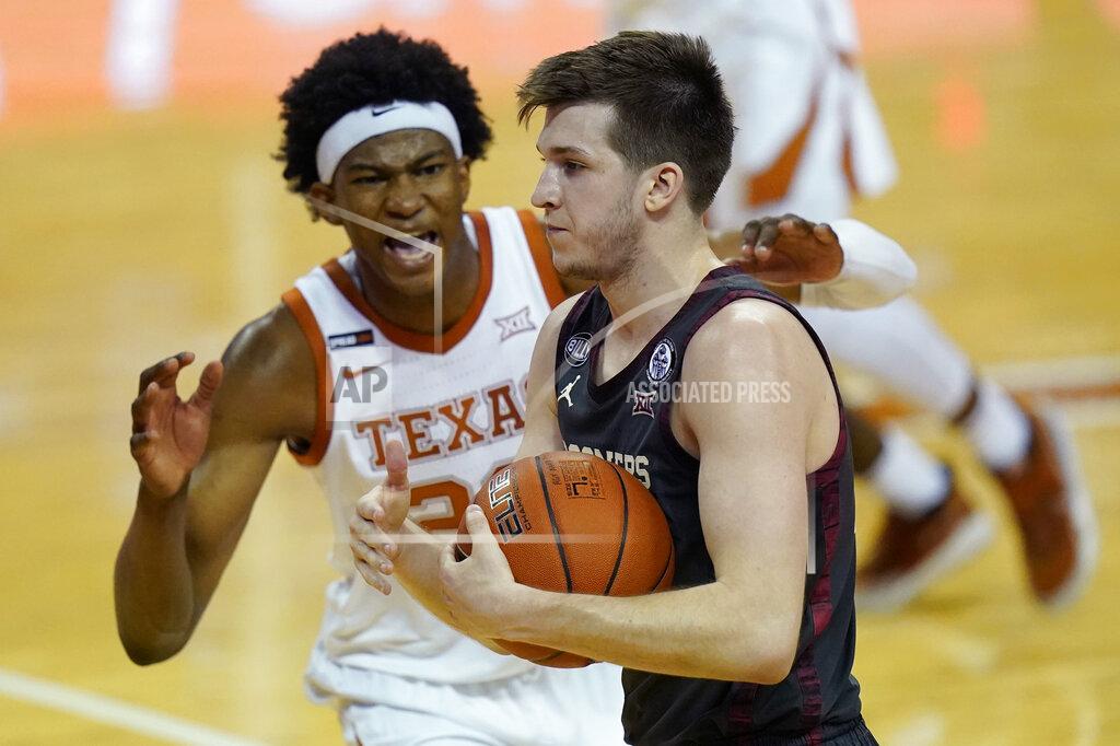 Eric Gay Oklahoma guard Austin Reaves, right, is defended by Texas forward Kai Jones (22) during the second half of an NCAA college basketball game Tuesday, Jan. 26, 2021, in Austin, Texas. (AP Photo/Eric Gay)